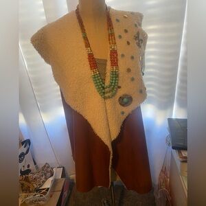 Unique faux suede vest . Vintage buttons with multi beaded necklace. Fun
